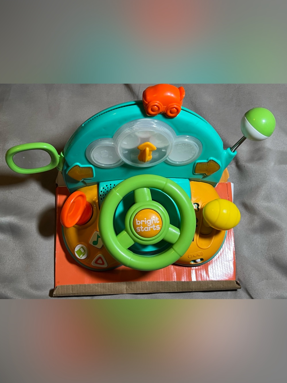 activity steering wheel in green and teal. Engaging buttons, spinning wheel 6+M